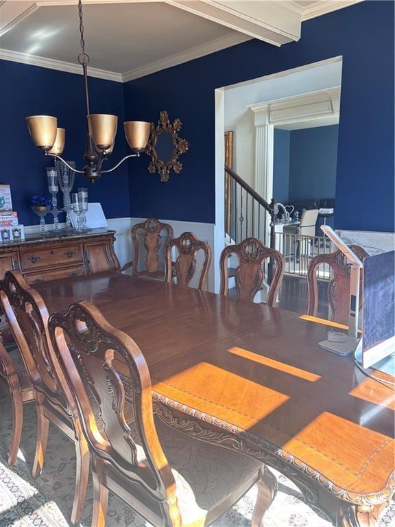 dining space featuring a notable chandelier and crown molding