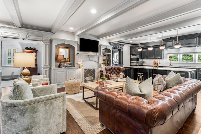 living room with ornamental molding, ornate columns, dark hardwood / wood-style floors, and beam ceiling