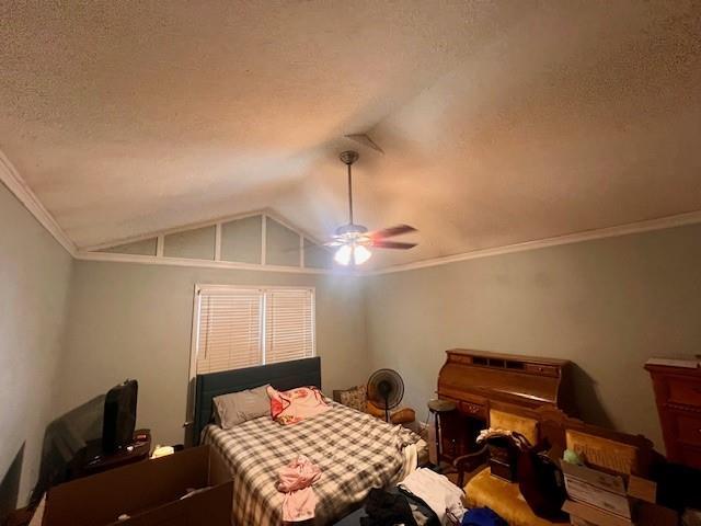 bedroom with crown molding, a textured ceiling, ceiling fan, and vaulted ceiling