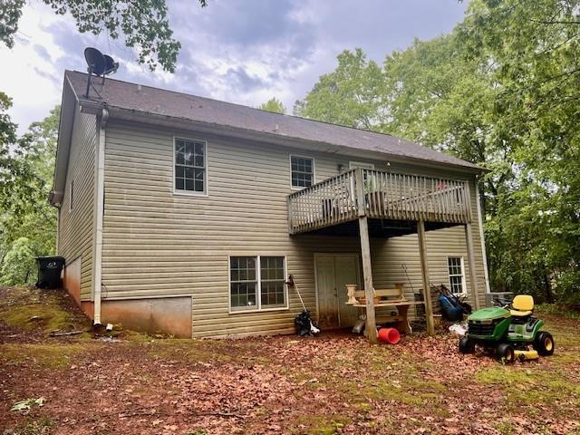 back of house featuring a deck