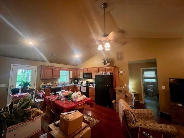 kitchen with ceiling fan, visible vents, black appliances, lofted ceiling, and dark wood-type flooring