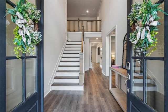 entryway featuring crown molding, french doors, and dark wood-type flooring