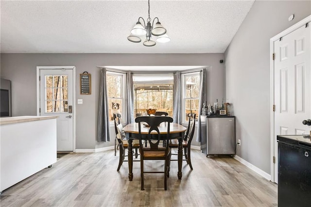 238 Brentwood Dr, Dallas, GA 30132 - dining area featuring light hardwood / wood-style floors, a textured ceiling, and an inviting chandelier