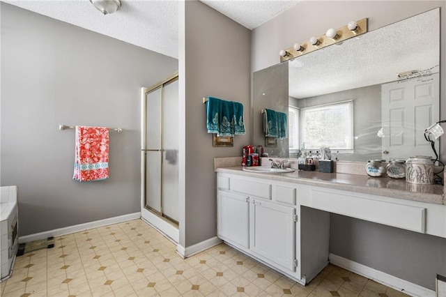 238 Brentwood Dr, Dallas, GA 30132 - bathroom with a textured ceiling, vanity, and an enclosed shower