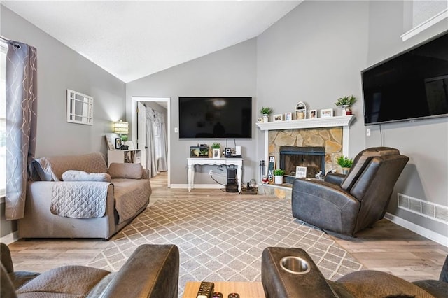 238 Brentwood Dr, Dallas, GA 30132 - living room featuring a fireplace, vaulted ceiling, and light hardwood / wood-style flooring