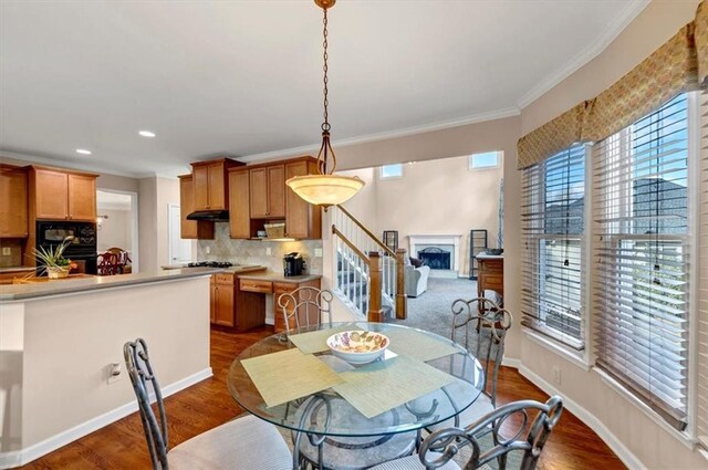 dining room featuring crown molding and dark wood-type flooring