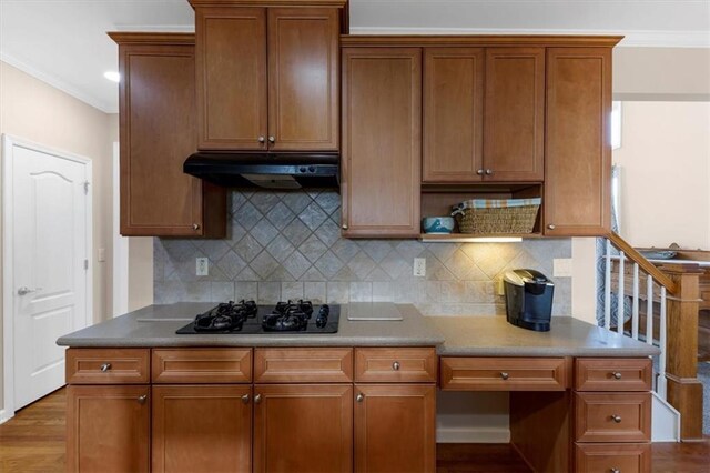 kitchen with decorative backsplash, black gas cooktop, crown molding, and wood-type flooring