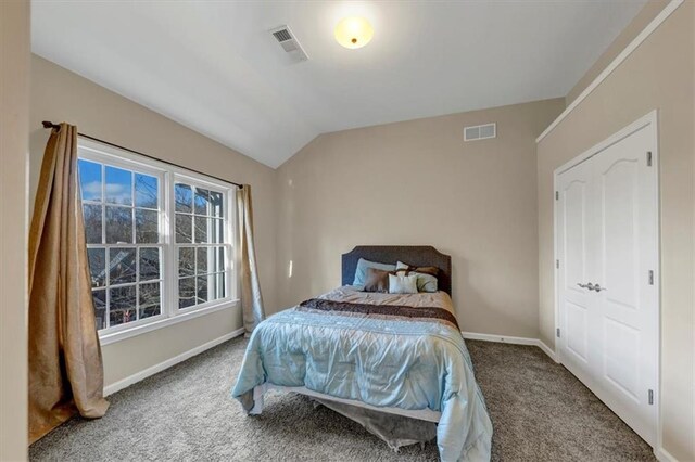 bedroom with carpet and vaulted ceiling