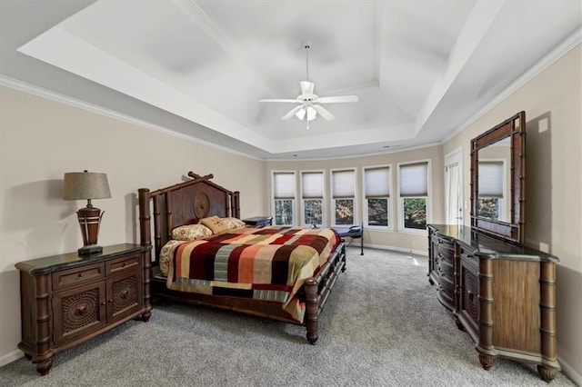 bedroom with ceiling fan, a raised ceiling, light colored carpet, and ornamental molding