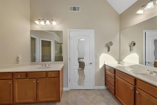 bathroom featuring tile patterned flooring, vanity, an enclosed shower, and lofted ceiling