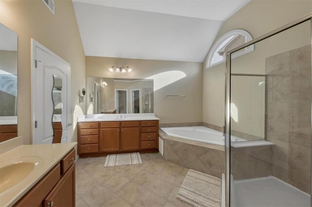 bathroom featuring tile patterned floors, vanity, independent shower and bath, and lofted ceiling