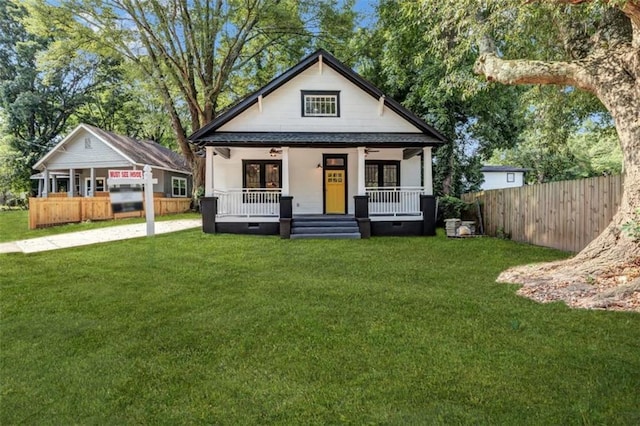 bungalow-style house with covered porch and a front yard