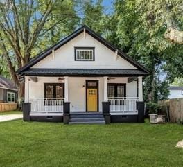 view of front of property with a porch and a front lawn