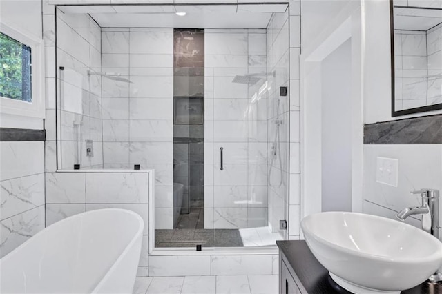 bathroom featuring separate shower and tub and vanity