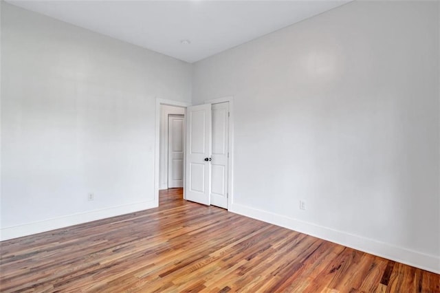 spare room featuring wood-type flooring