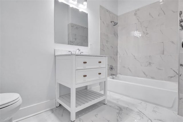 full bathroom with toilet, tiled shower / bath, and vanity