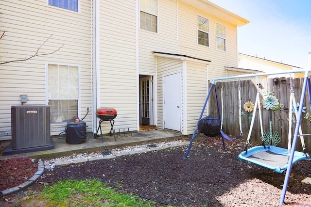 back of house featuring cooling unit