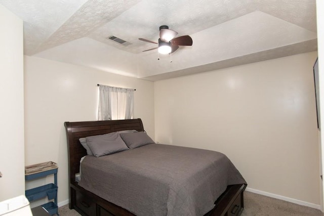 bedroom featuring a ceiling fan, a textured ceiling, light colored carpet, and baseboards