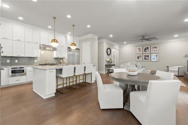 2811 Shady Valley Dr NE, Brookhaven, GA 30324 - dining space with crown molding and dark wood-style flooring
