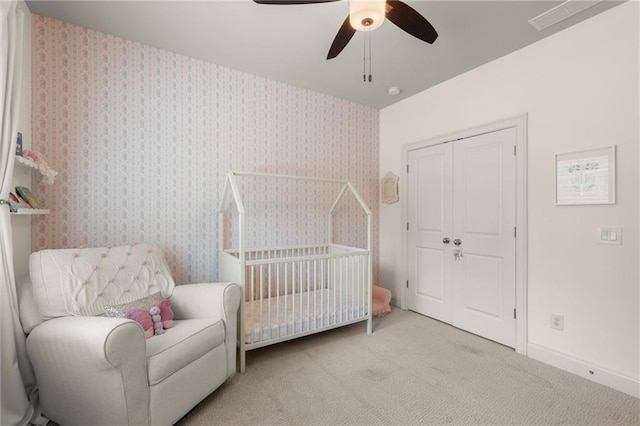 2811 Shady Valley Dr NE, Brookhaven, GA 30324 - bedroom with ceiling fan, visible vents, a crib, baseboards, and light carpet
