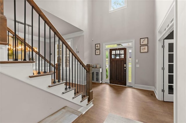 2811 Shady Valley Dr NE, Brookhaven, GA 30324 - entryway with crown molding, recessed lighting, wood finished floors, and stairway