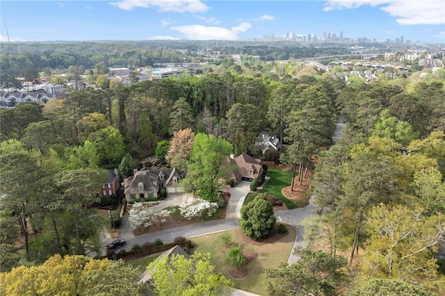 2811 Shady Valley Dr NE, Brookhaven, GA 30324 - view of front of home featuring board and batten siding, driveway, a front yard, fence, and stone siding