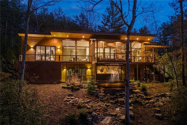 303 Clarice Ln, Sautee Nacoochee, GA 30571 - back of house at night with stairway and a wooden deck
