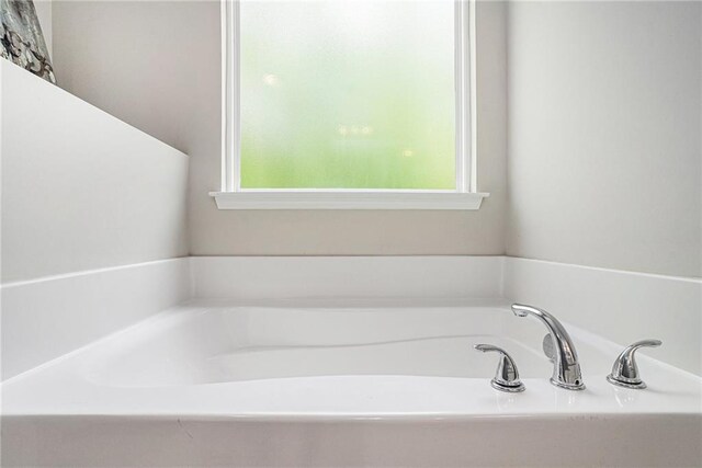 full bathroom with a bath and a wealth of natural light