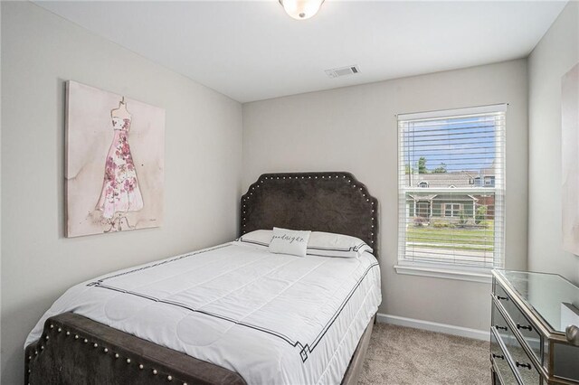 bedroom featuring baseboards, multiple windows, light carpet, and visible vents
