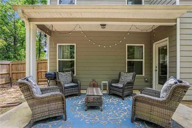 view of patio featuring fence and an outdoor hangout area