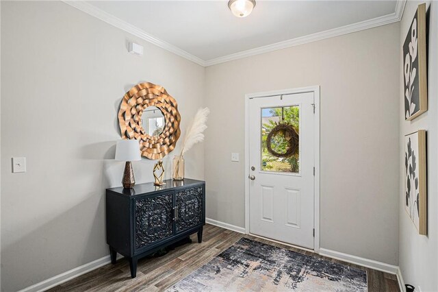 entrance foyer with baseboards, ornamental molding, and wood finished floors