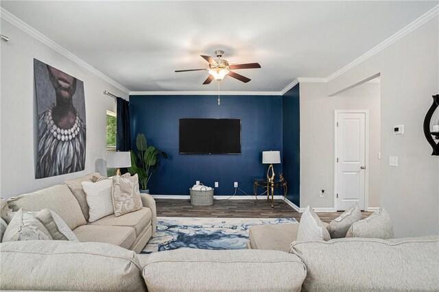 living room with crown molding, baseboards, ceiling fan, and wood finished floors