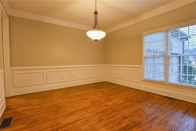 empty room with crown molding and hardwood / wood-style floors