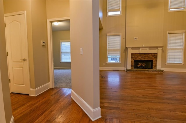 hall featuring dark hardwood / wood-style flooring and a high ceiling