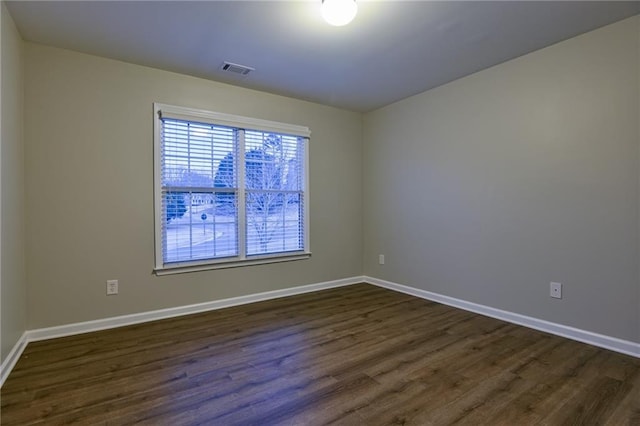 empty room featuring dark wood-type flooring