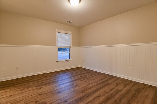 empty room with dark wood-type flooring