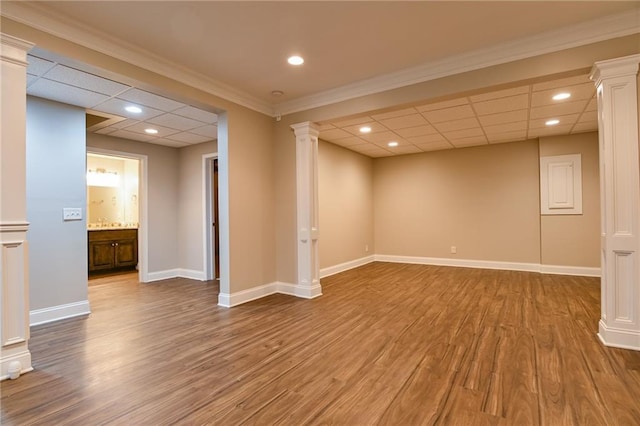 basement with hardwood / wood-style flooring and a paneled ceiling