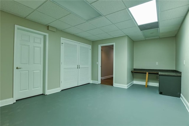 basement featuring a drop ceiling