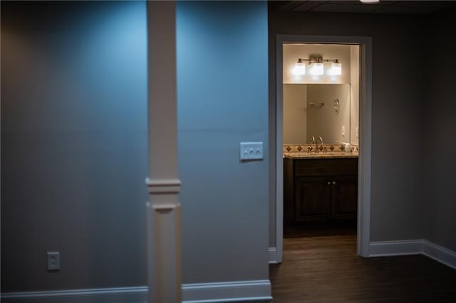 hallway with dark wood-type flooring and sink