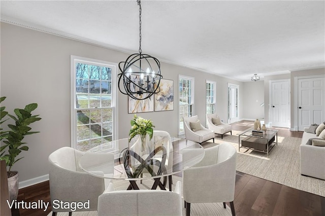 dining space featuring crown molding, a notable chandelier, dark wood finished floors, and baseboards