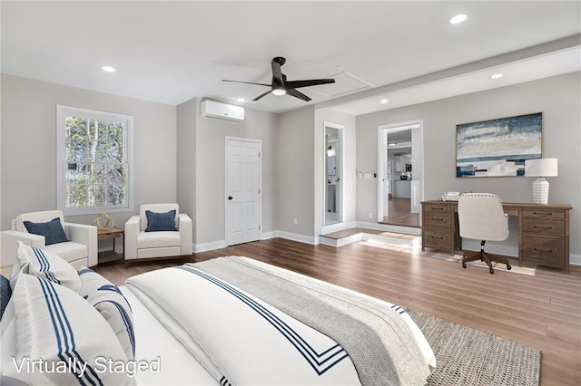 bedroom featuring baseboards, a wall mounted AC, wood finished floors, and recessed lighting