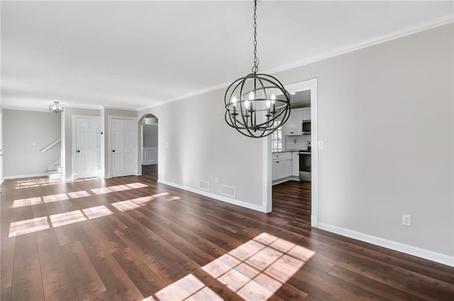 interior space with arched walkways, dark wood-type flooring, and baseboards