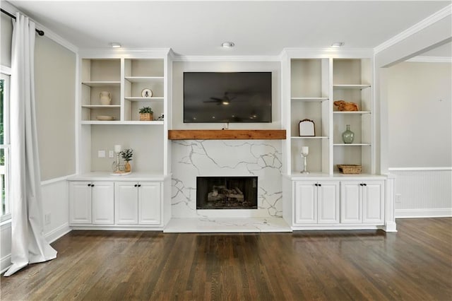 5807 Brookstone Walk NW, Acworth, GA 30101 - unfurnished living room featuring dark wood-type flooring, a premium fireplace, built in features, wainscoting, and ornamental molding