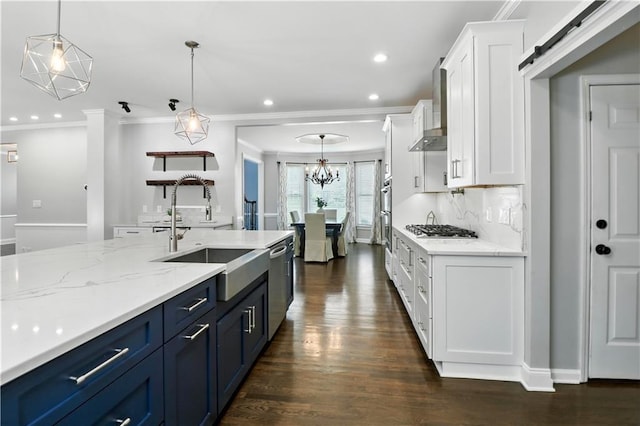 5807 Brookstone Walk NW, Acworth, GA 30101 - kitchen with wall chimney exhaust hood, appliances with stainless steel finishes, crown molding, white cabinets, and dark wood-style floors