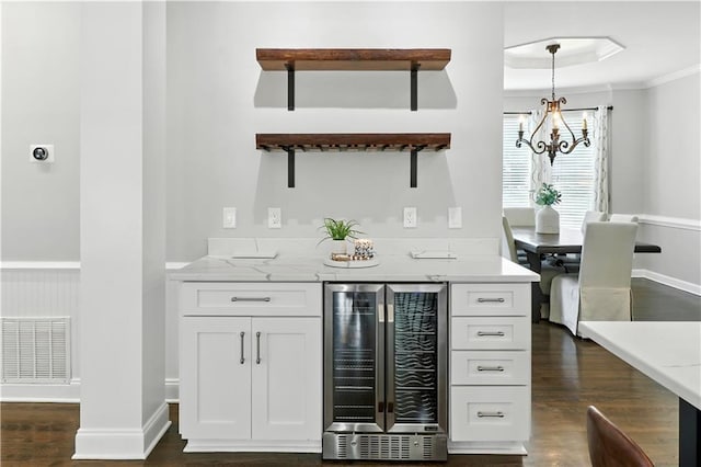 5807 Brookstone Walk NW, Acworth, GA 30101 - indoor bar with wine cooler, dark wood-style floors, crown molding, a chandelier, and hanging light fixtures