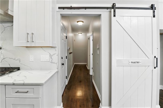 5807 Brookstone Walk NW, Acworth, GA 30101 - hall with dark wood-type flooring and a barn door