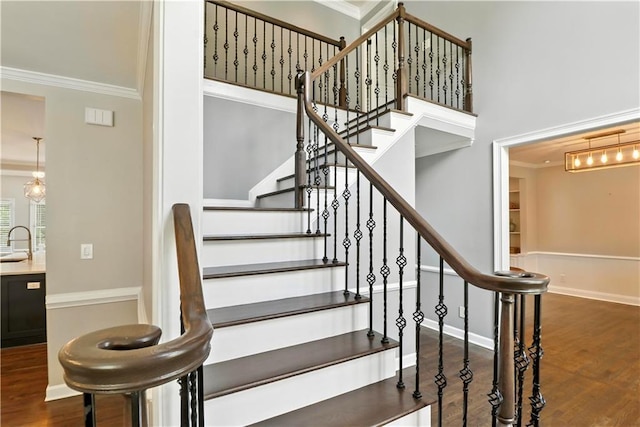 5807 Brookstone Walk NW, Acworth, GA 30101 - stairs featuring crown molding, wood finished floors, and a towering ceiling