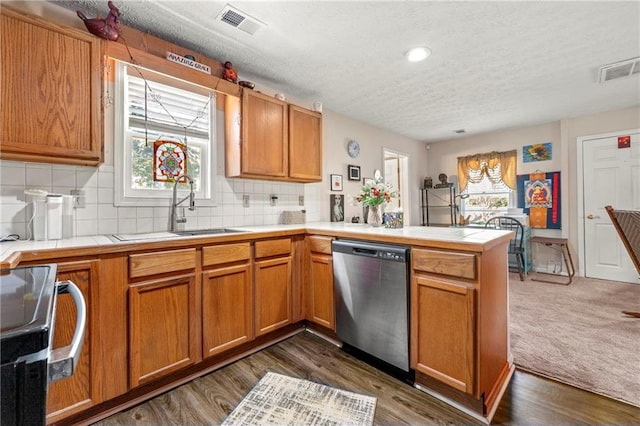 kitchen featuring tile countertops, visible vents, electric range, stainless steel dishwasher, and a peninsula