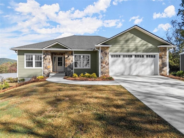 view of front of house with a garage and a front yard