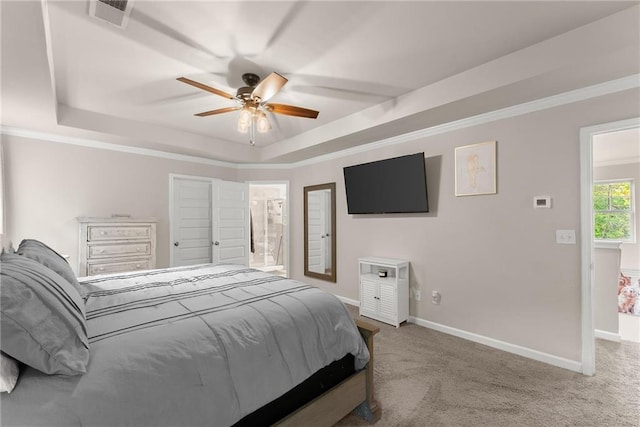 bedroom with a tray ceiling, carpet flooring, baseboards, and ornamental molding